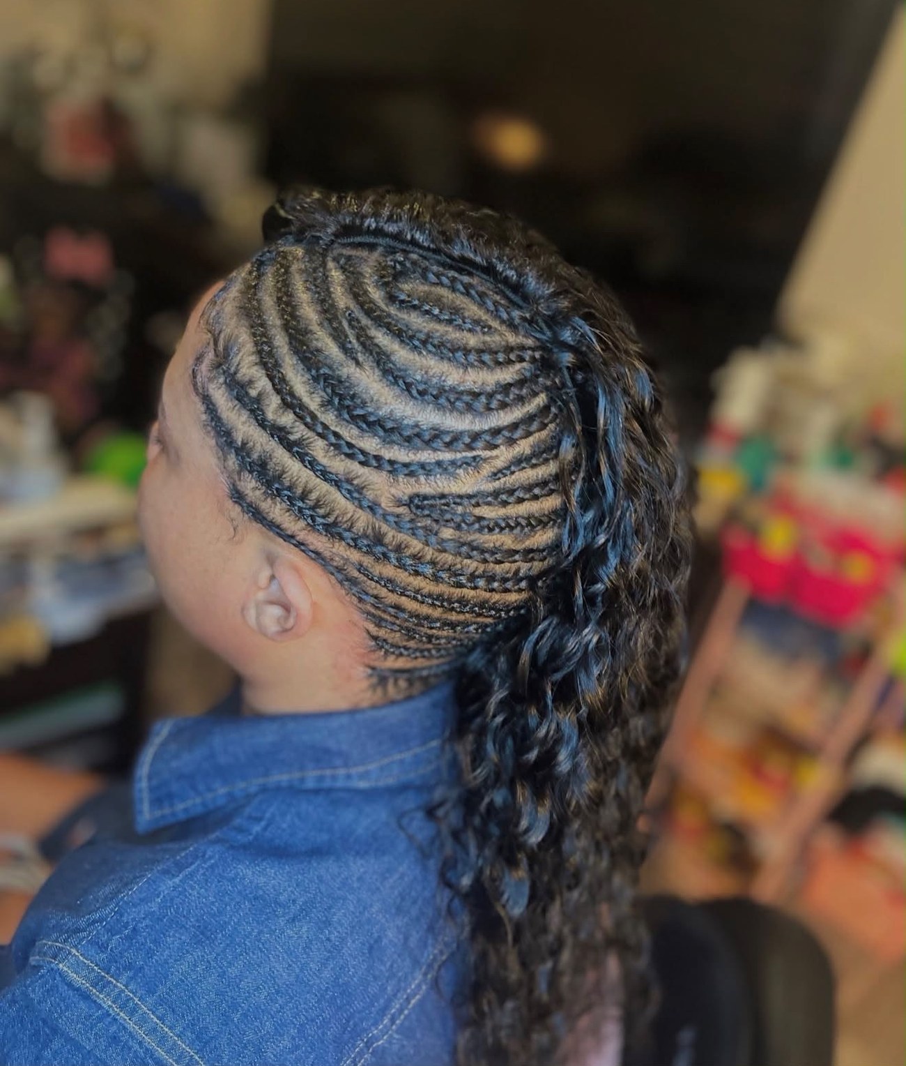 Feed-in braids with curly ponytail, side view