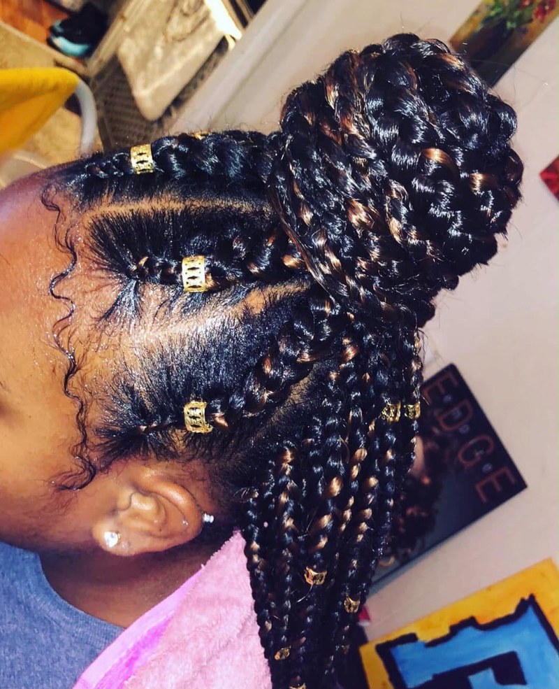 Jumbo braids in a bun with gold cuffs